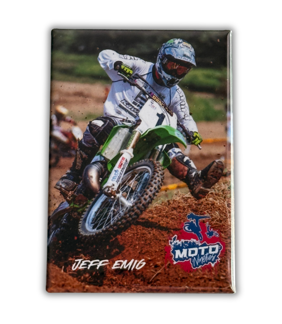 Jeff Emig racing through a dirt berm on his number 1 motocross bike during a 1990s motocross race.