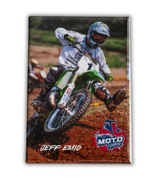 Jeff Emig racing through a dirt berm on his number 1 motocross bike during a 1990s motocross race.