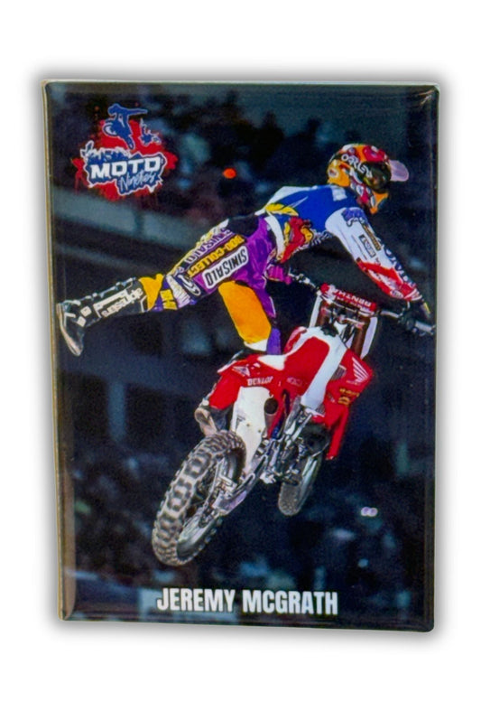 Motocross action scene with a rider performing a trick, featuring Jeremy McGrath branding. Nac Nac.