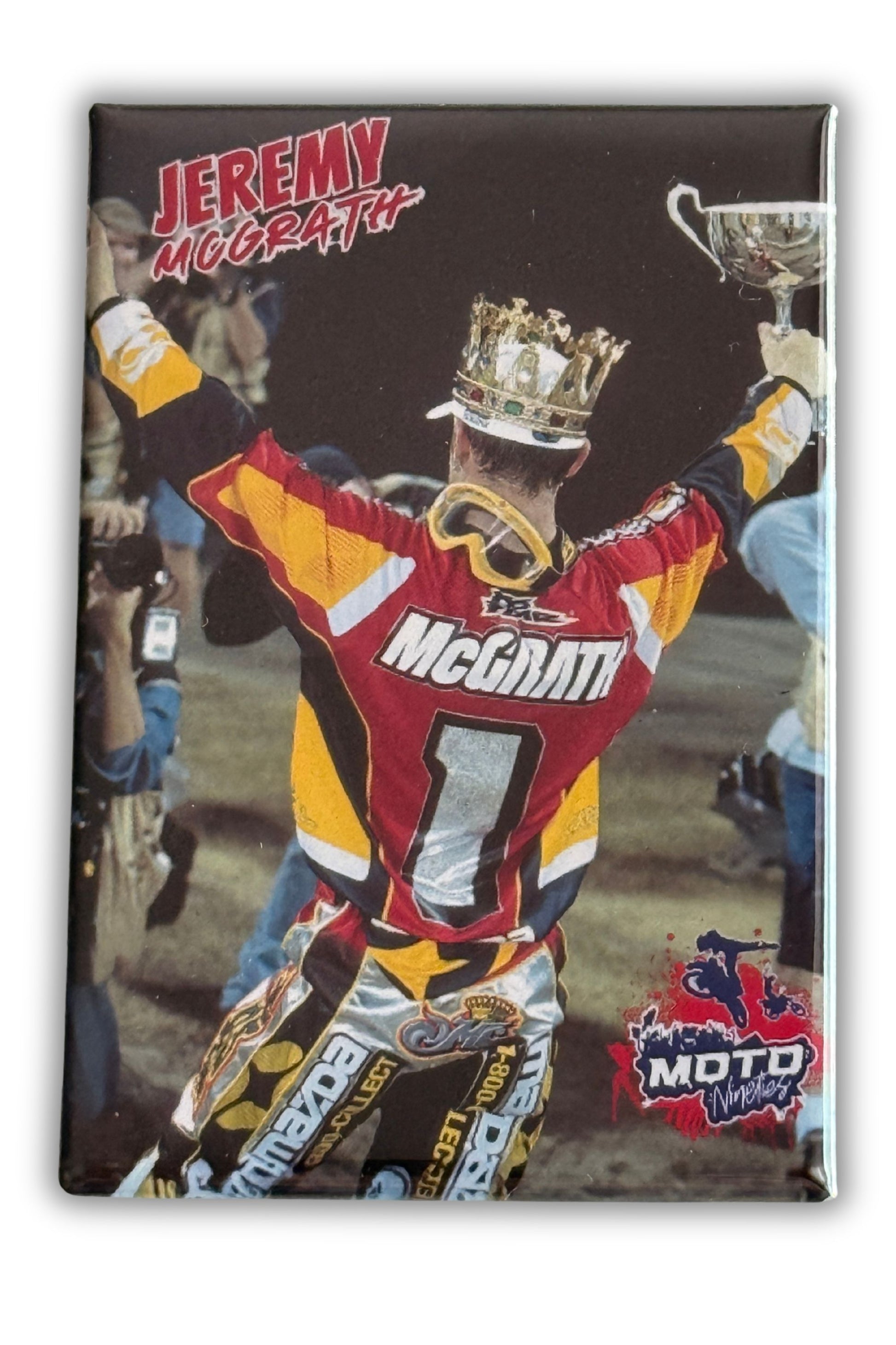Jeremy McGrath celebrating a Supercross championship victory while wearing a crown and holding a trophy. Moto Nineties™ collectible magnet.
